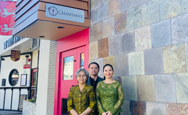 Julie Chantanee and Family in front of Restaurant